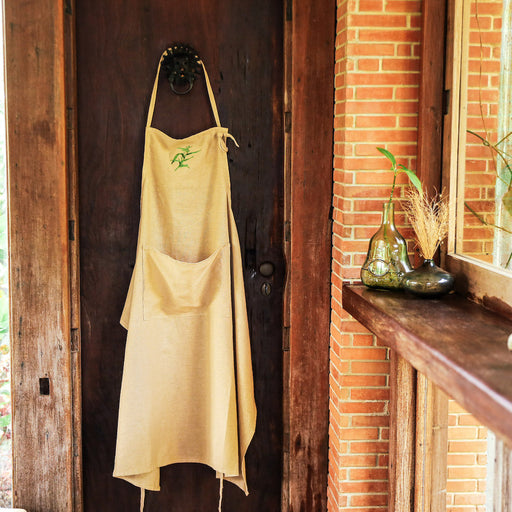 Keep your dress spiff while baking up a storm in this long linen apron, detailed with an intricately embroidered adlai plant to pay homage to our local indigenous crops. Wrap the straps all-around your waist to hold your kitchen towels, and use the handy front pocket to keep your phone or your thermometer in close reach. The neck strap loops into a hole to keep it adjustable for all family members! Lovingly made in the Philippines. Baking essentials available online through Domesticity.