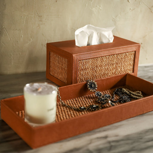 A set comes with a rectangular tissue box cover and a vanity tray that stores your essential toiletries and hand towels on your bathroom counter.  Made in the Philippines from woven rattan mat and faux leather material.   